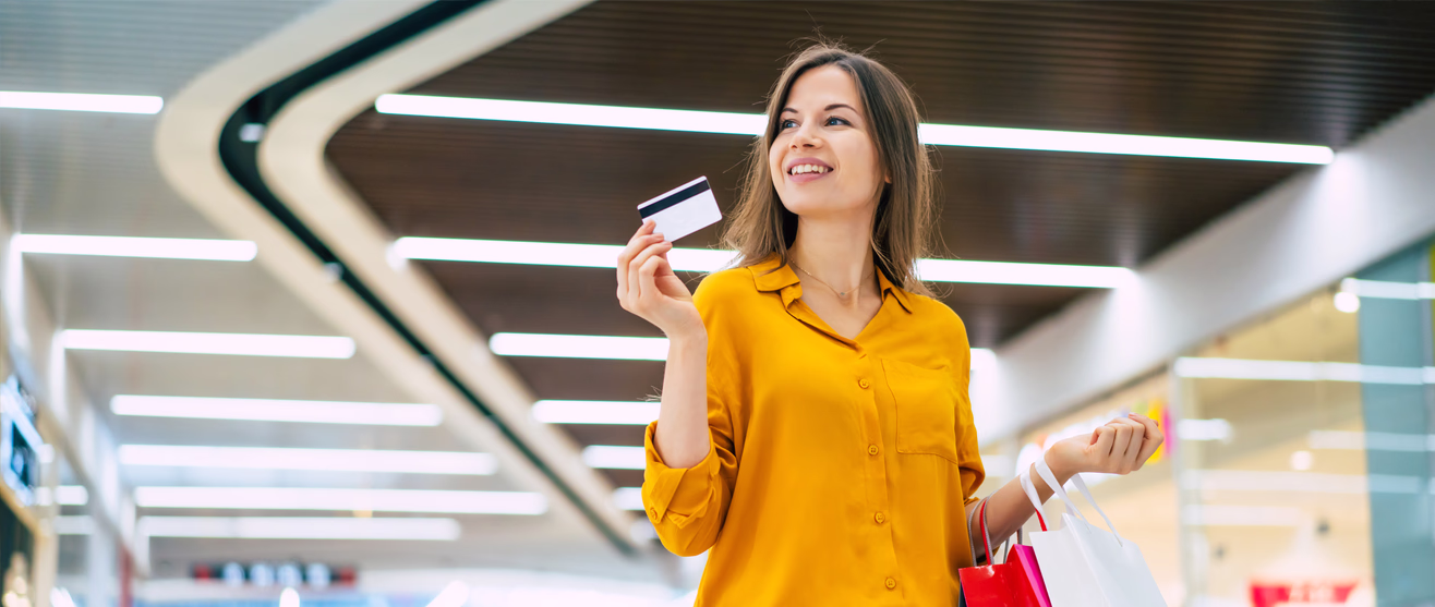 Shopper in a mall making a contactless payment with a card