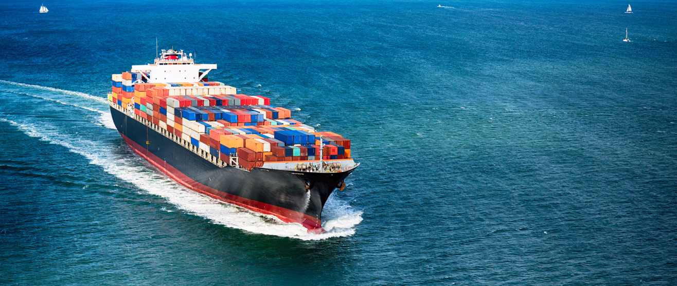 Container ship navigating a busy harbor